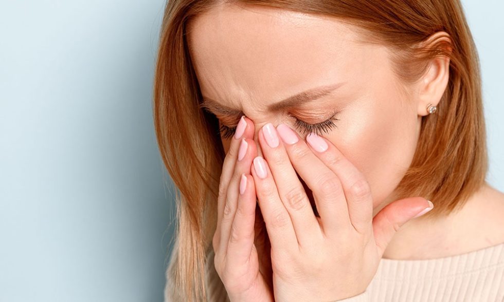 Woman having a dry eye disease
